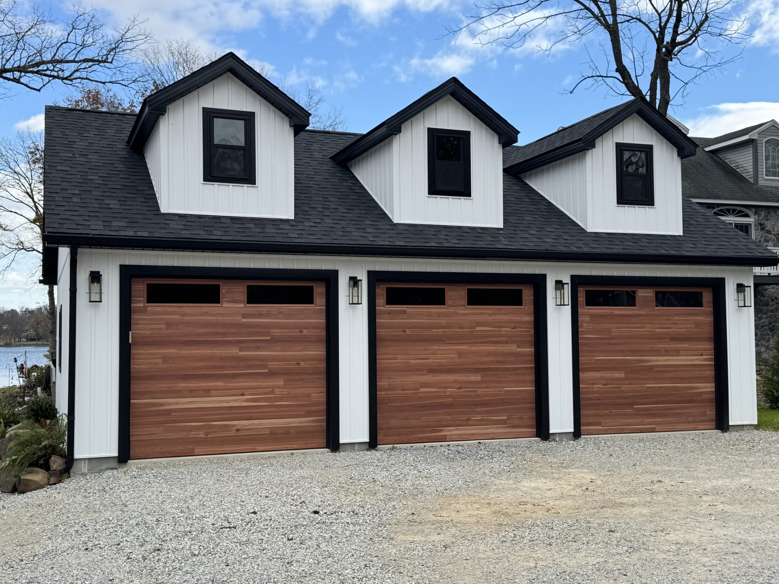 A three-car garage with wooden doors.